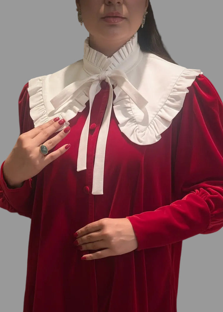 Red blouse with a white ruffled collar on a gray background