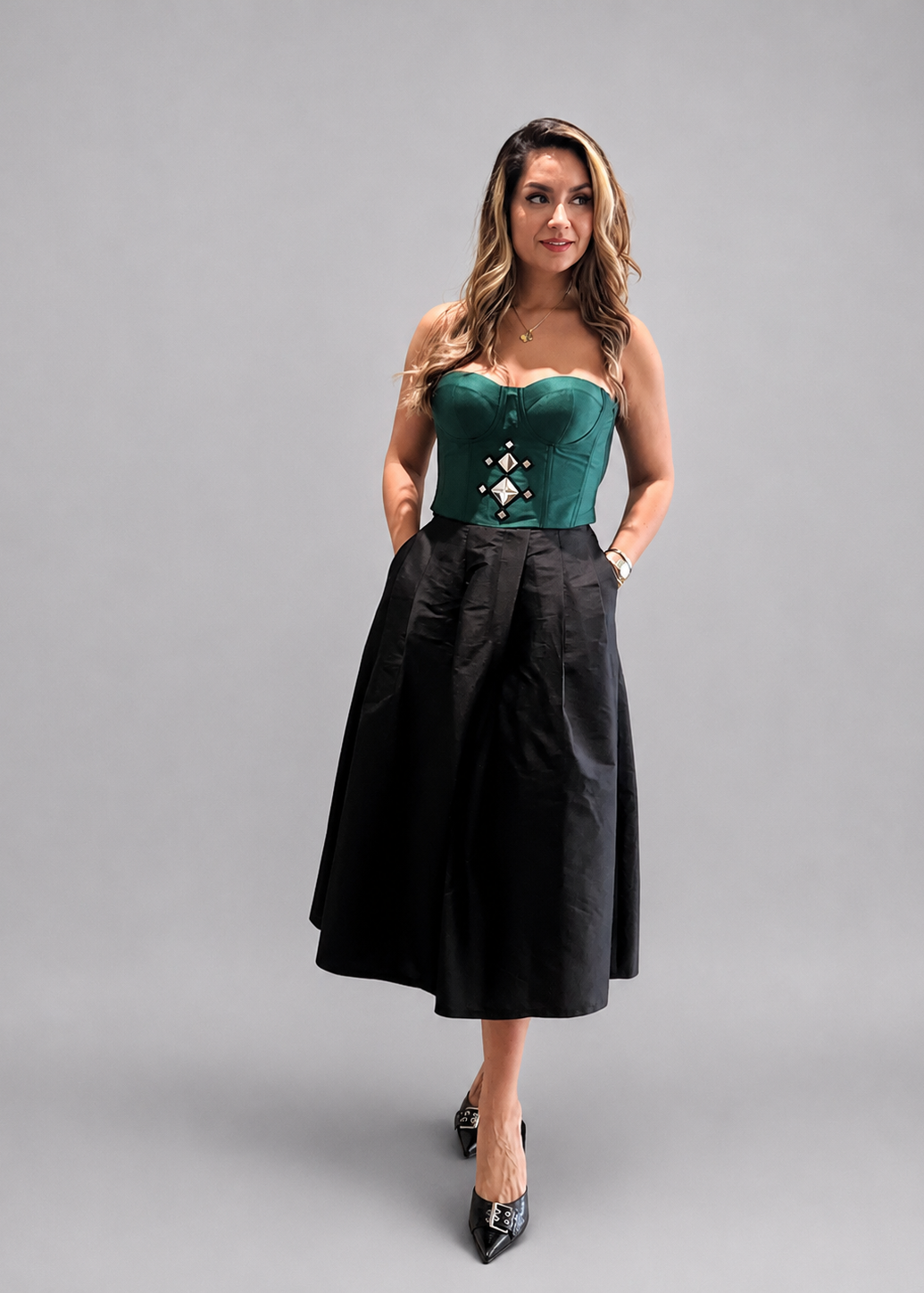 Green crop top with decorative pattern on a white background