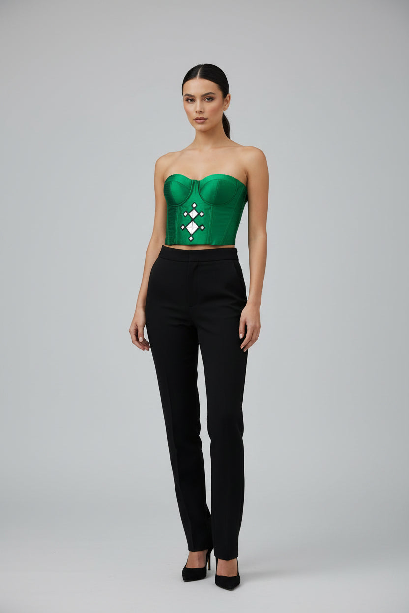 Green crop top with decorative pattern on a white background