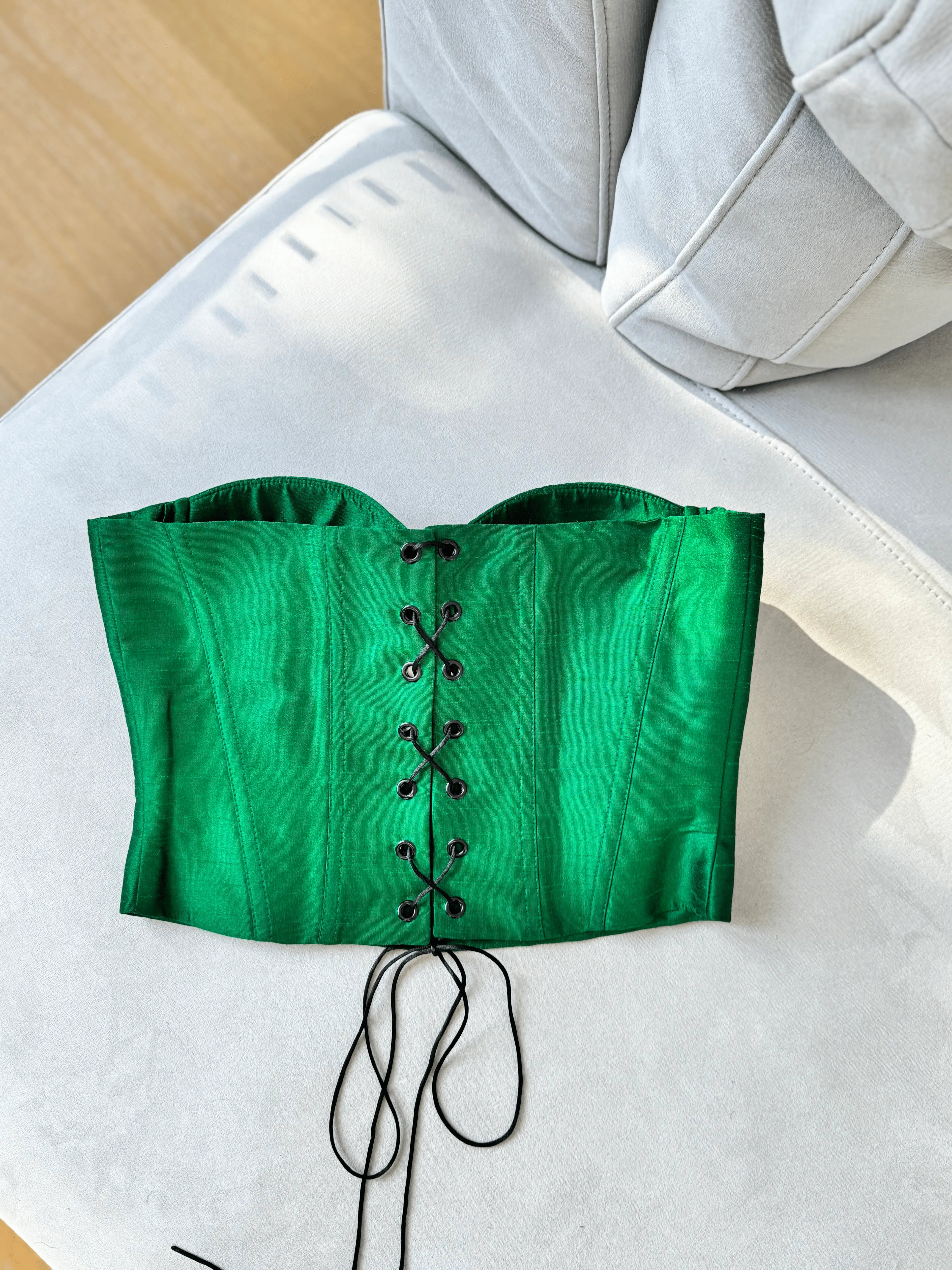 Green crop top with decorative pattern on a white background