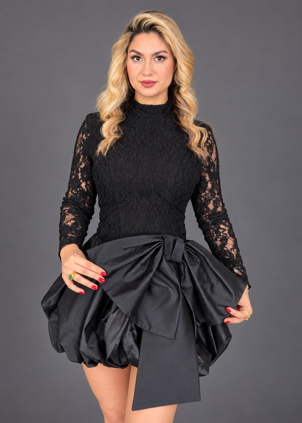 black mini dress combining a fitted lace bodice with a voluminous bubble skirt